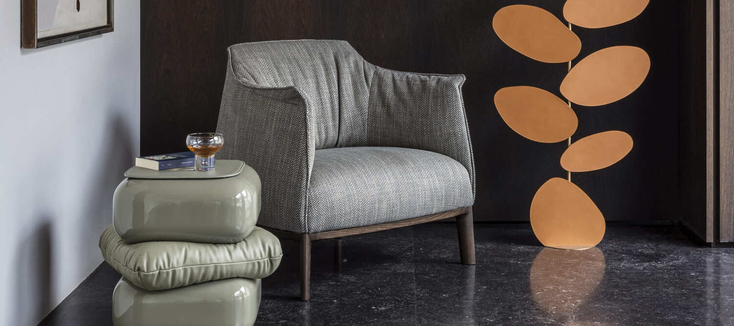 Archibald armchair by Poltrona Frau, with wooden base and Pelle Frau® leather with handcrafted stitching, elegant and modern style